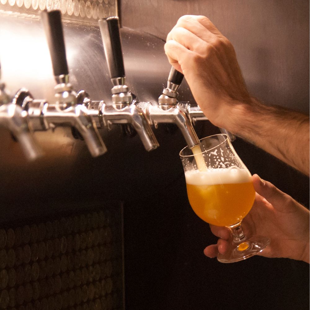 Pouring beer Pouring beer in a taproom and brewing marketing is important to continue to grow business.